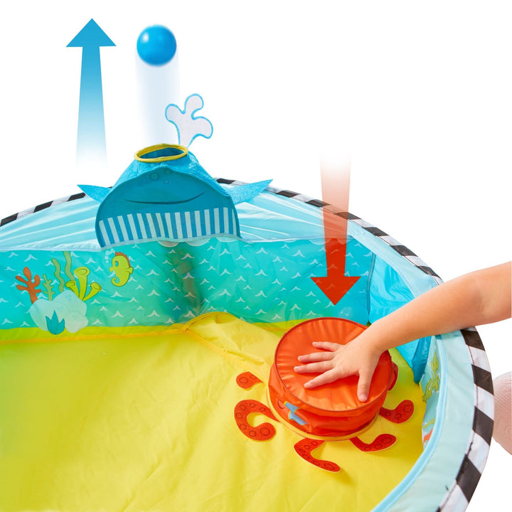 Kid playing with Undersea Pop Up Baby Sensory Ball Pit featuring whale balloon launcher and crab ball fountain for fun and coordination.