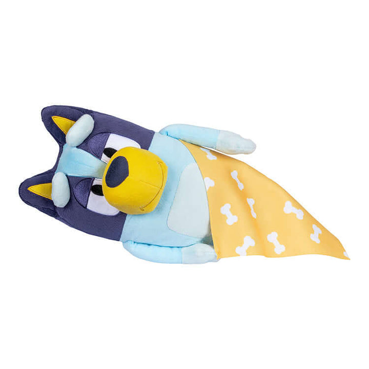 Sleepytime Bluey plush toy with yellow blanket, featuring sleepy eyes and multilingual sound effects in English, French, and Spanish.