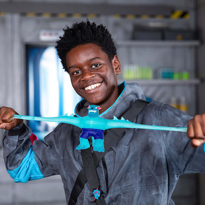 Child playing with MrBeast Lab Goo Jit Zu Iconic Panther, stretching the squishy hero toy in a fun lab setting.