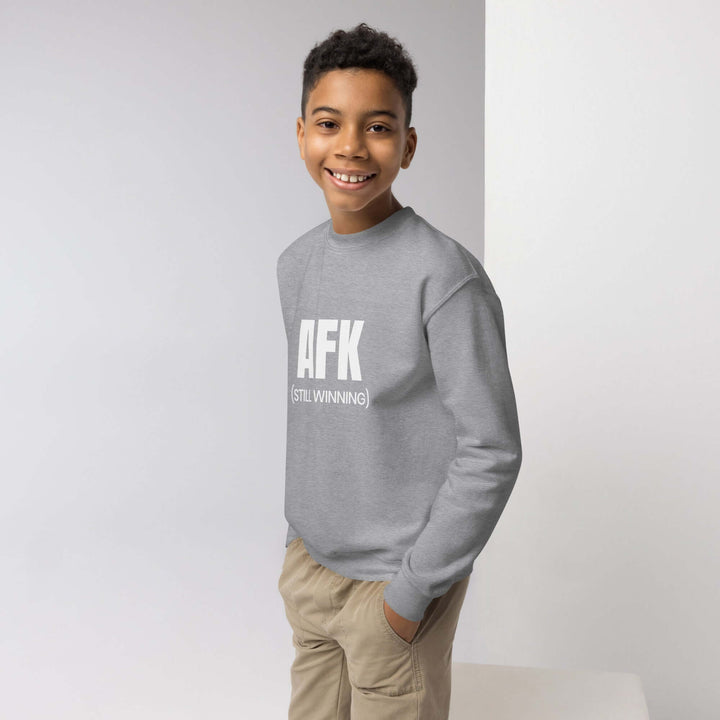AFK Youth crewneck sweatshirt worn by a smiling boy, showcasing comfort and style for active youth.