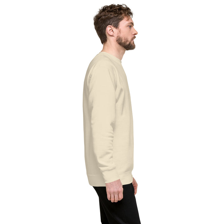 Side view of a man wearing an Earthlets unisex premium sweatshirt in beige, showcasing its classic silhouette.