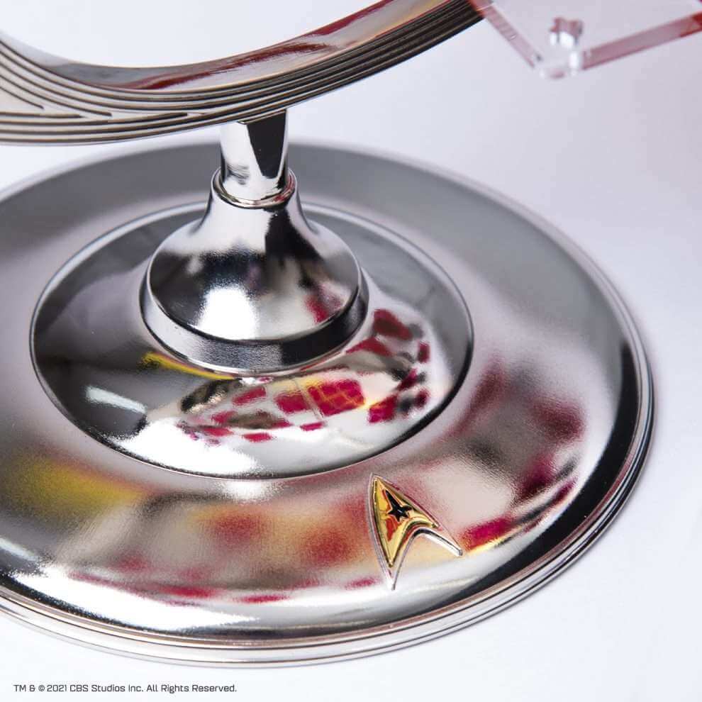 Close-up of the base of the Star Trek Tri-Dimensional Chess Set, showcasing the shiny zinc alloy and Starship emblem.