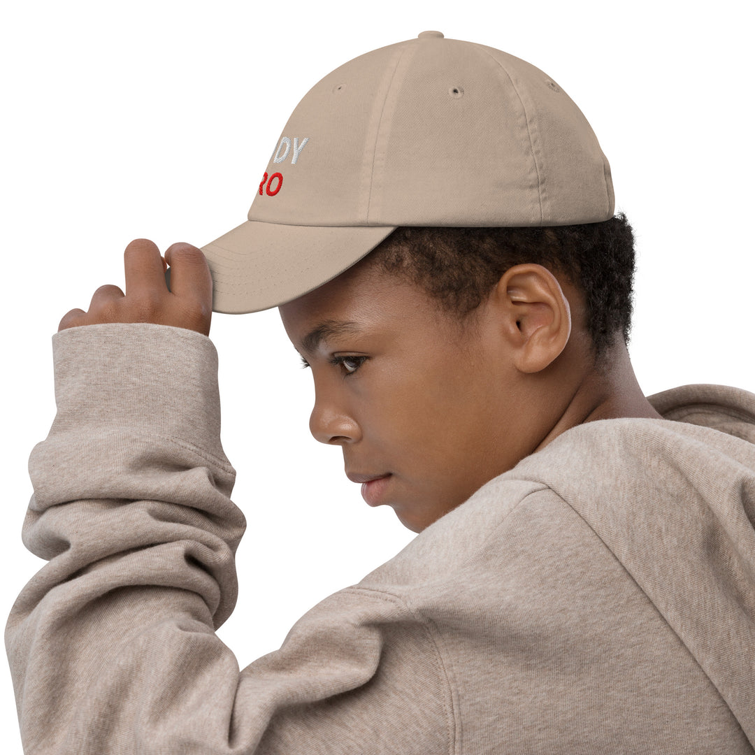 Oddy Pro Youth baseball cap worn by a child, showcasing a stylish design and comfortable fit for outdoor activities.